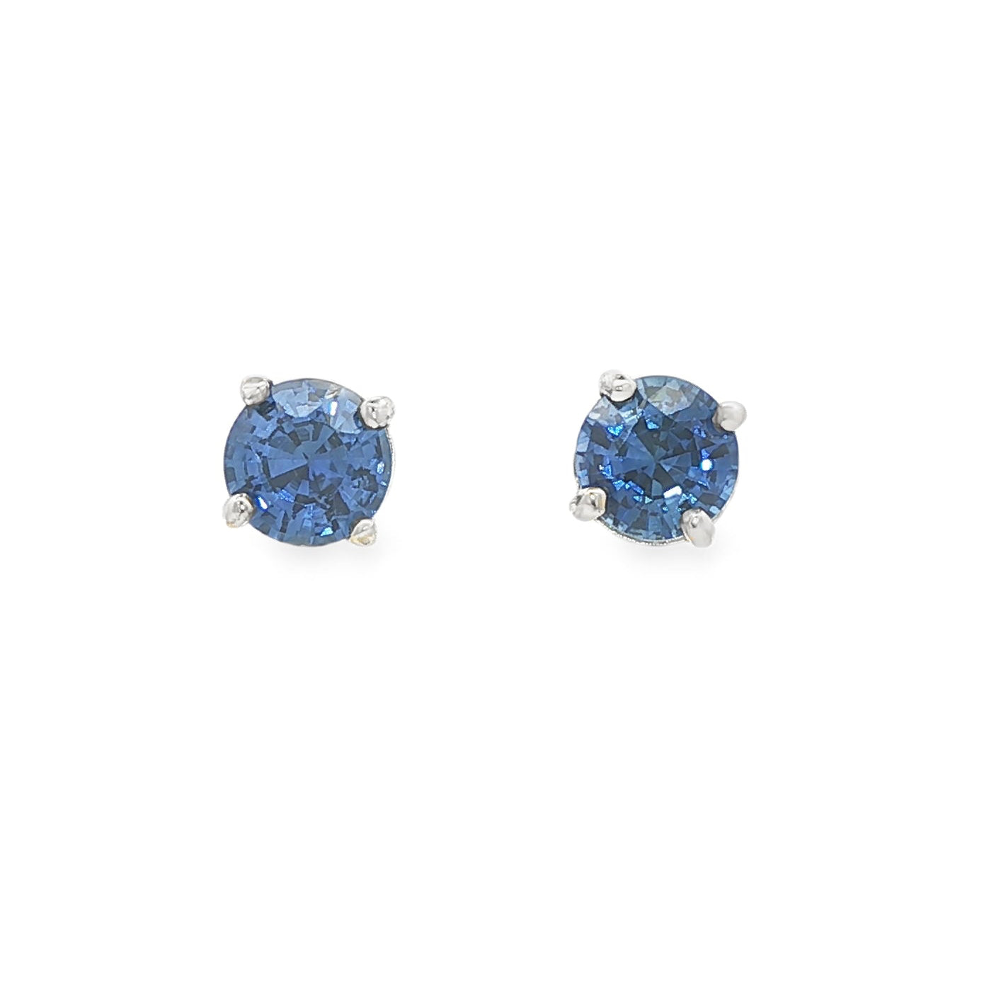 14K White gold stud earrings set with round blue sapphires. Item J37904 - ABC Jewelry