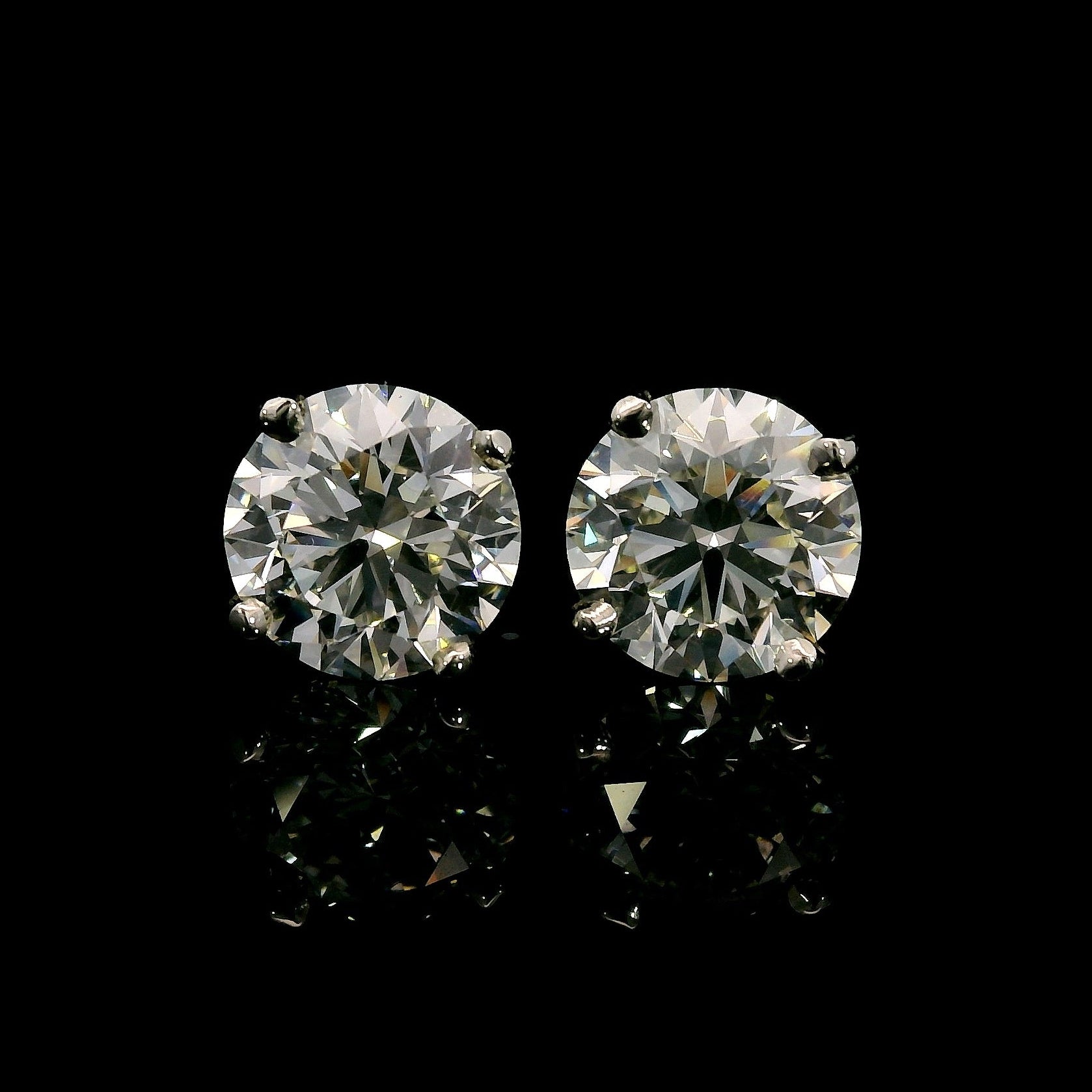 14K White gold studs set with round brilliant diamonds. Item J37909 - ABC Jewelry Co. 
