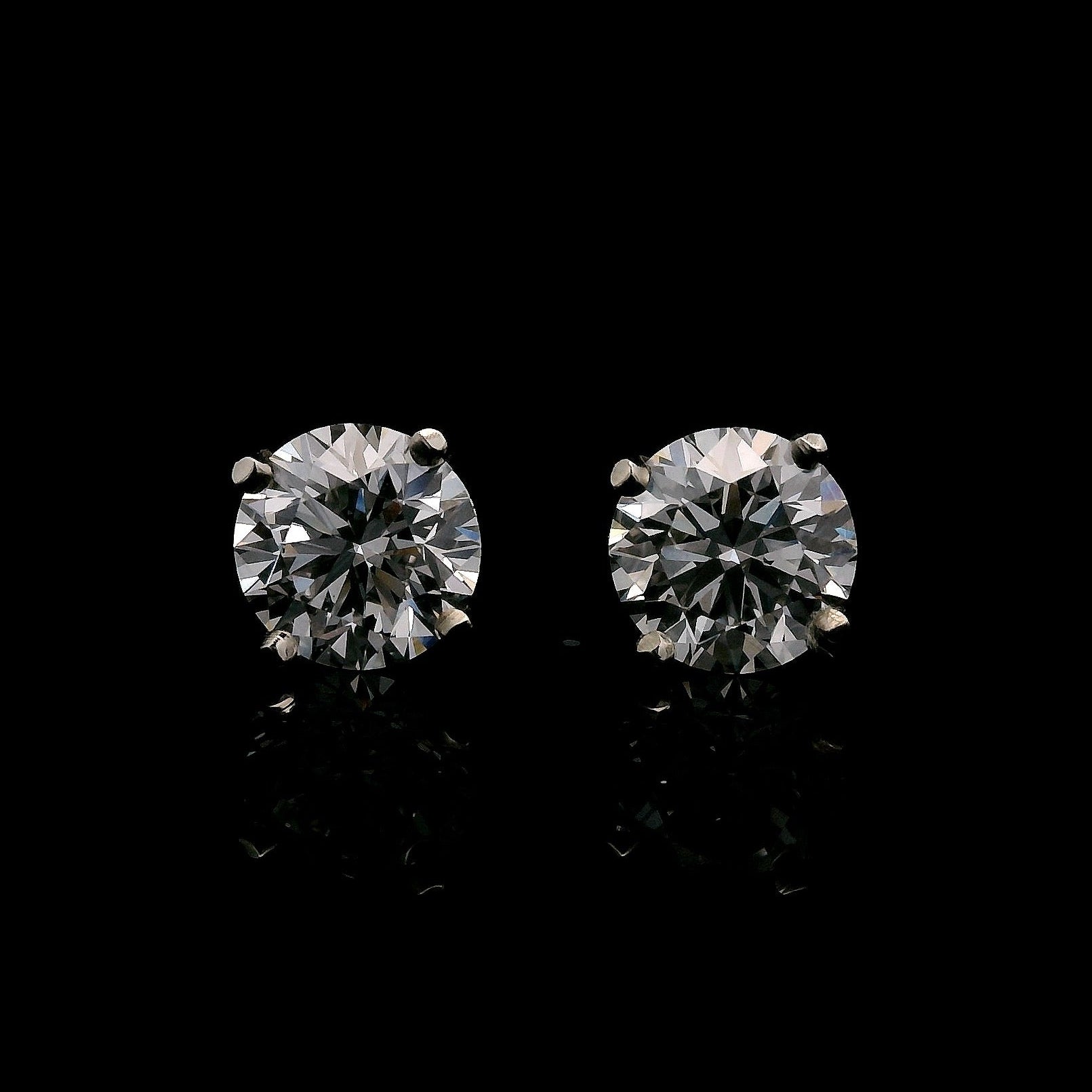 14K White gold stud earrings set with round brilliant diamonds. Item J37948 - ABC Jewelry Co. 