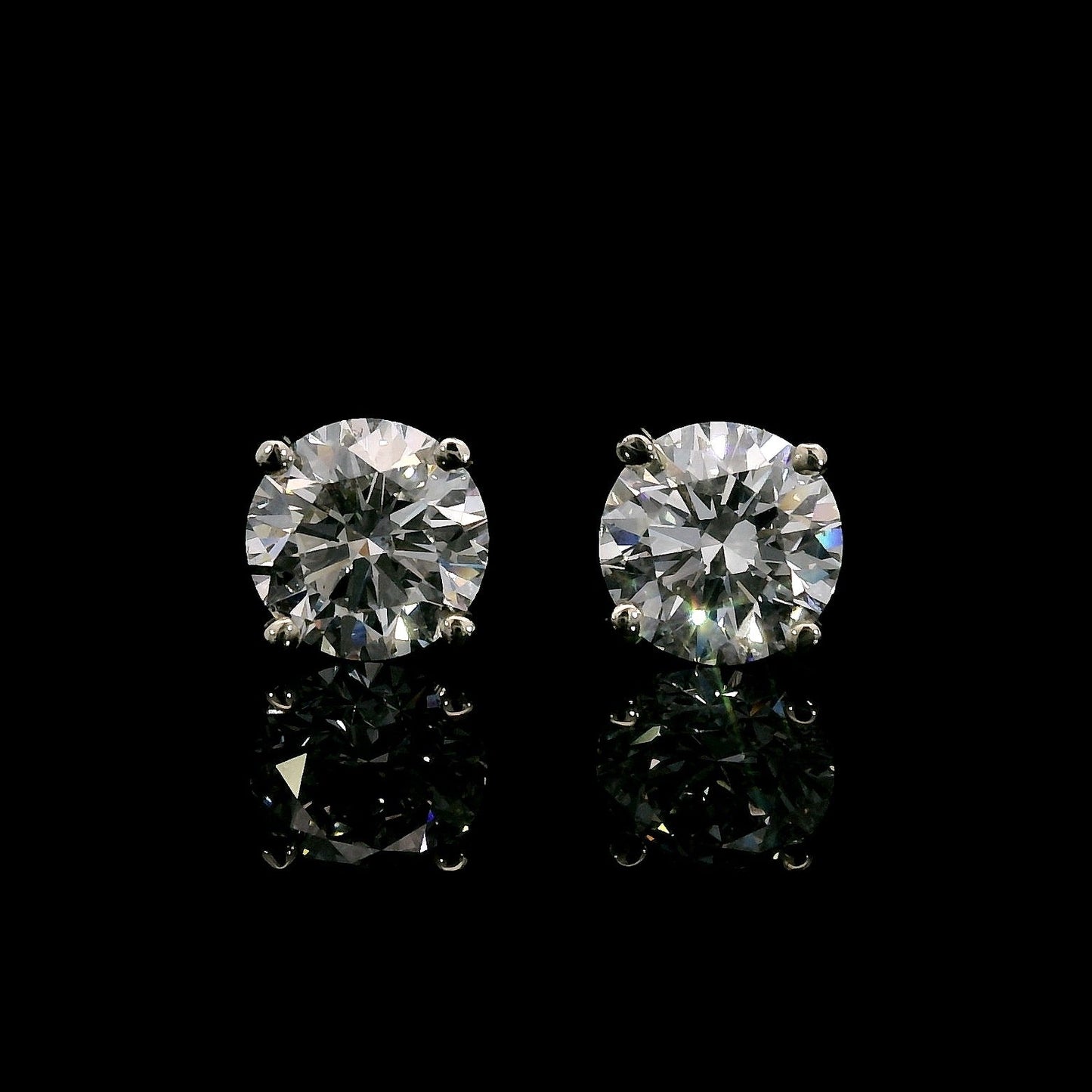14K White gold studs set with round brilliant diamonds. Item J37952 - ABC Jewelry Co. 