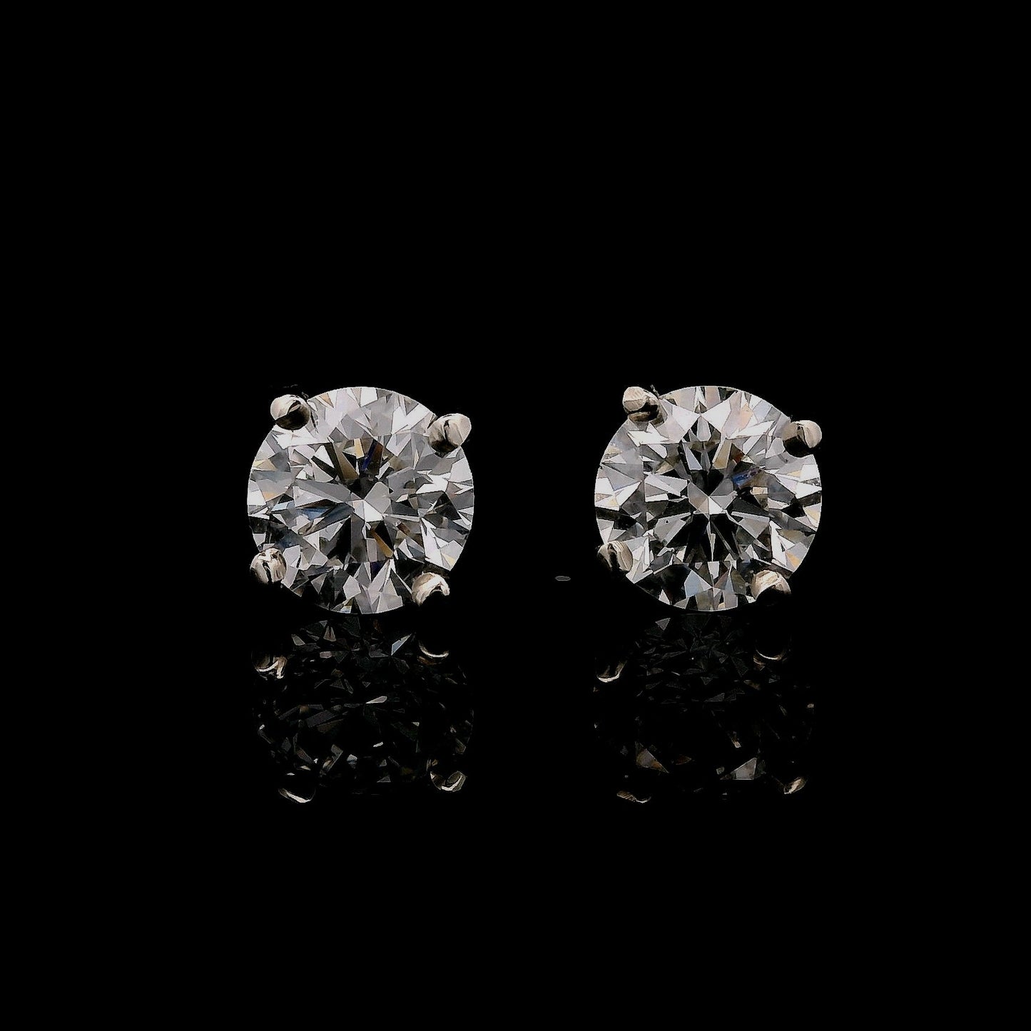 14K White gold stud earrings set with round brilliant diamonds. Item J37987 - ABC Jewelry Co. 
