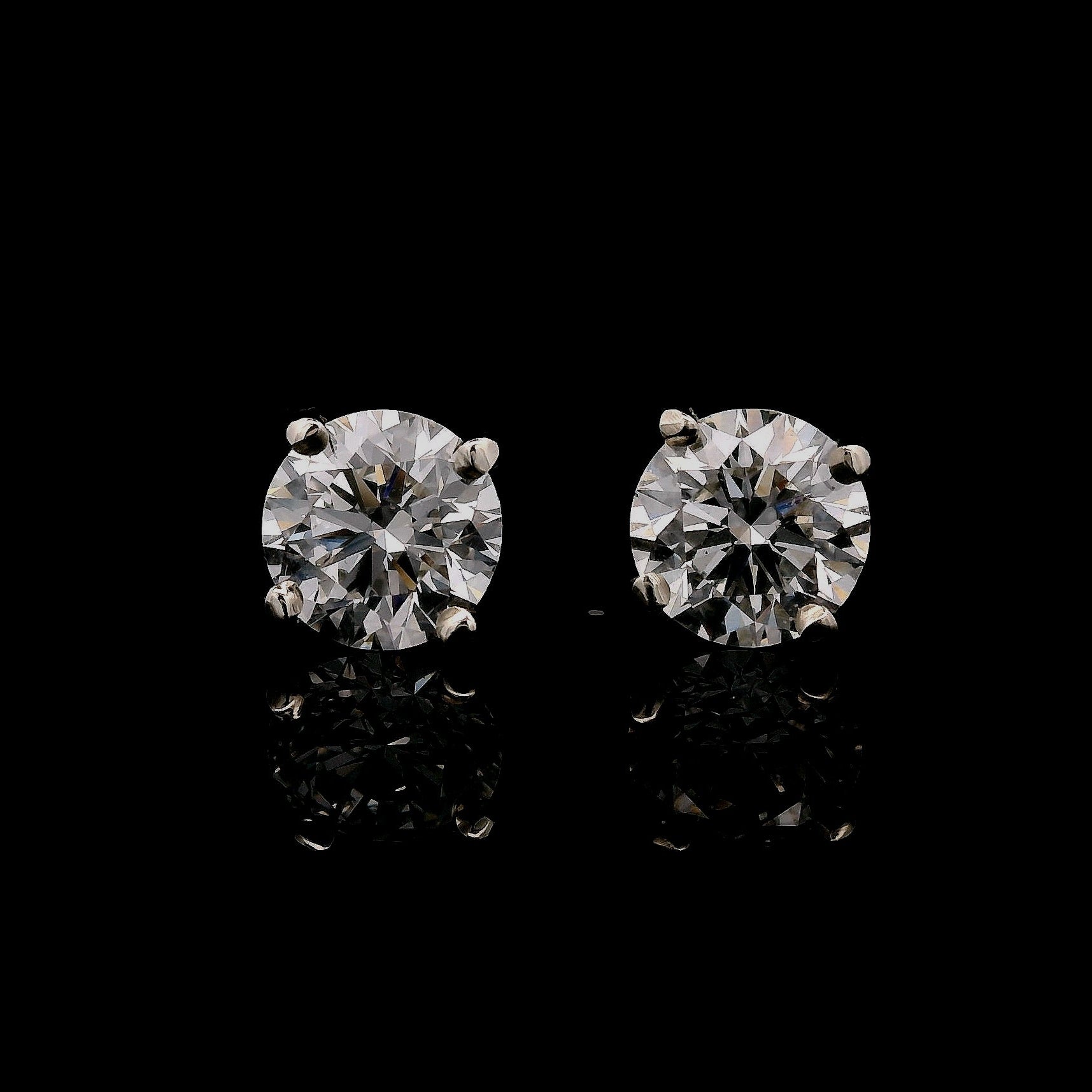 14K White gold stud earrings set with round brilliant diamonds. Item J37987 - ABC Jewelry Co. 