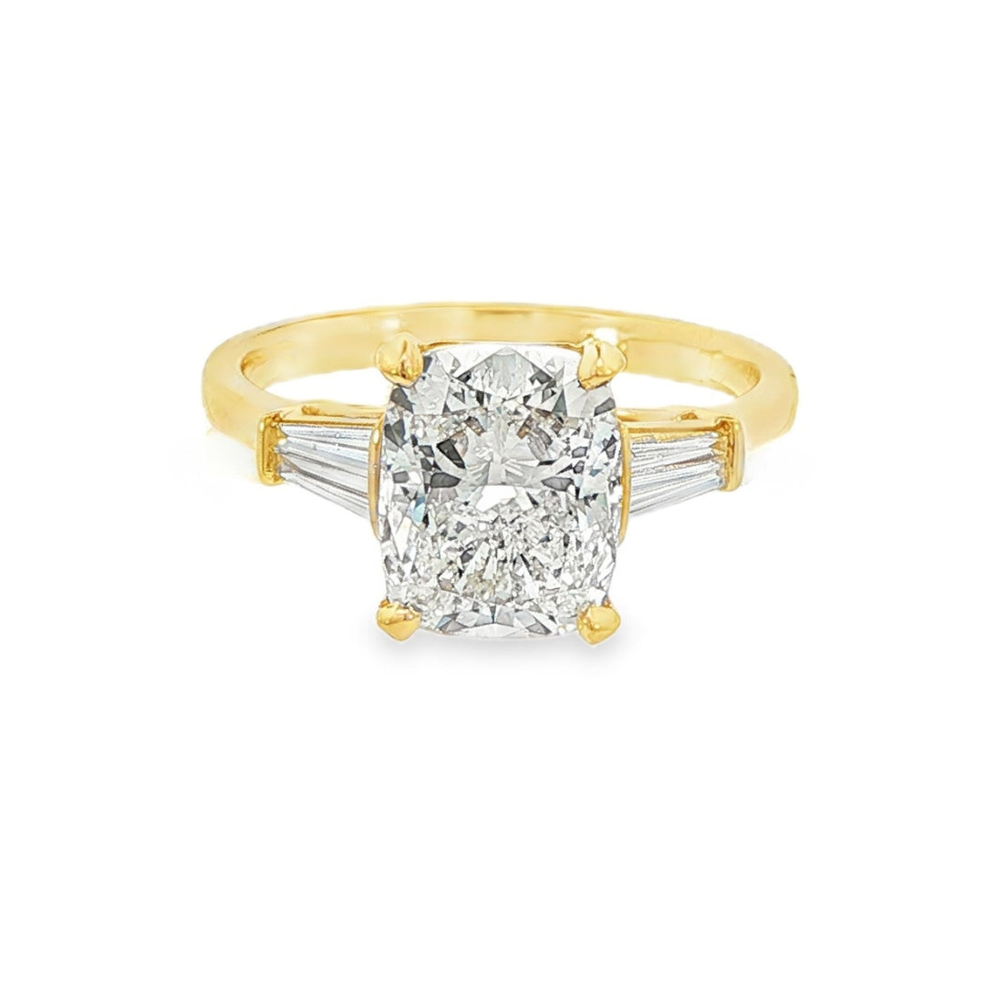 14K Yellow gold engagement ring set with a cushion cut center diamond and accented with 4 tapered baguette diamonds. Item J38008- ABC Jewelry Co. 