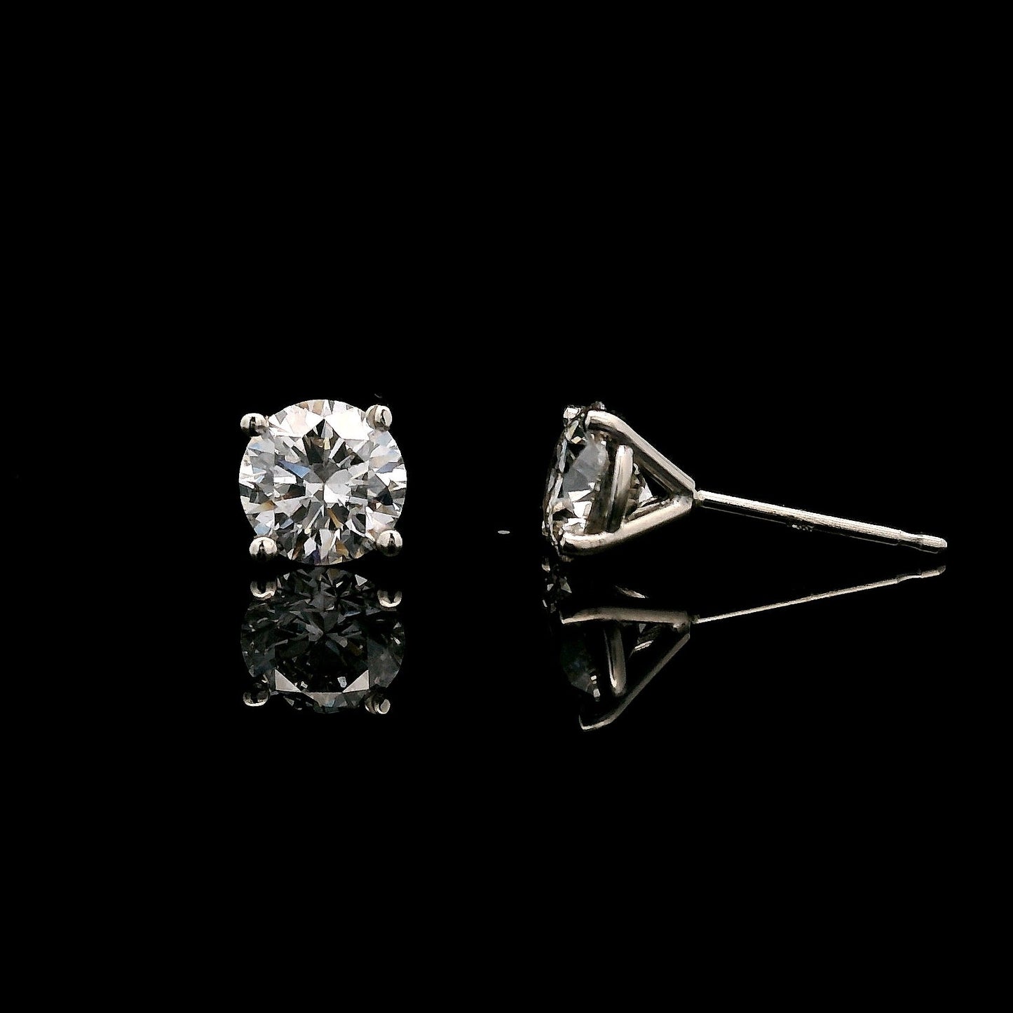 14K White gold stud earrings set with round brilliant diamonds. Item J38154 - ABC Jewelry Co