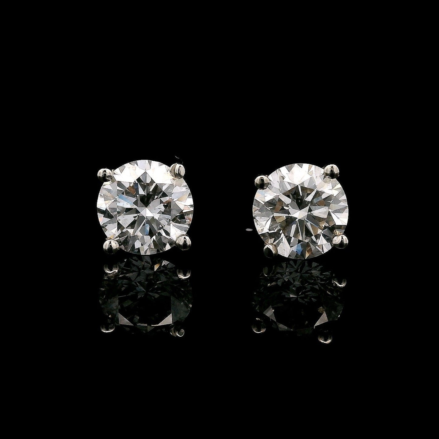 14K White gold stud earrings set with round brilliant diamonds. Item J38154 - ABC Jewelry Co