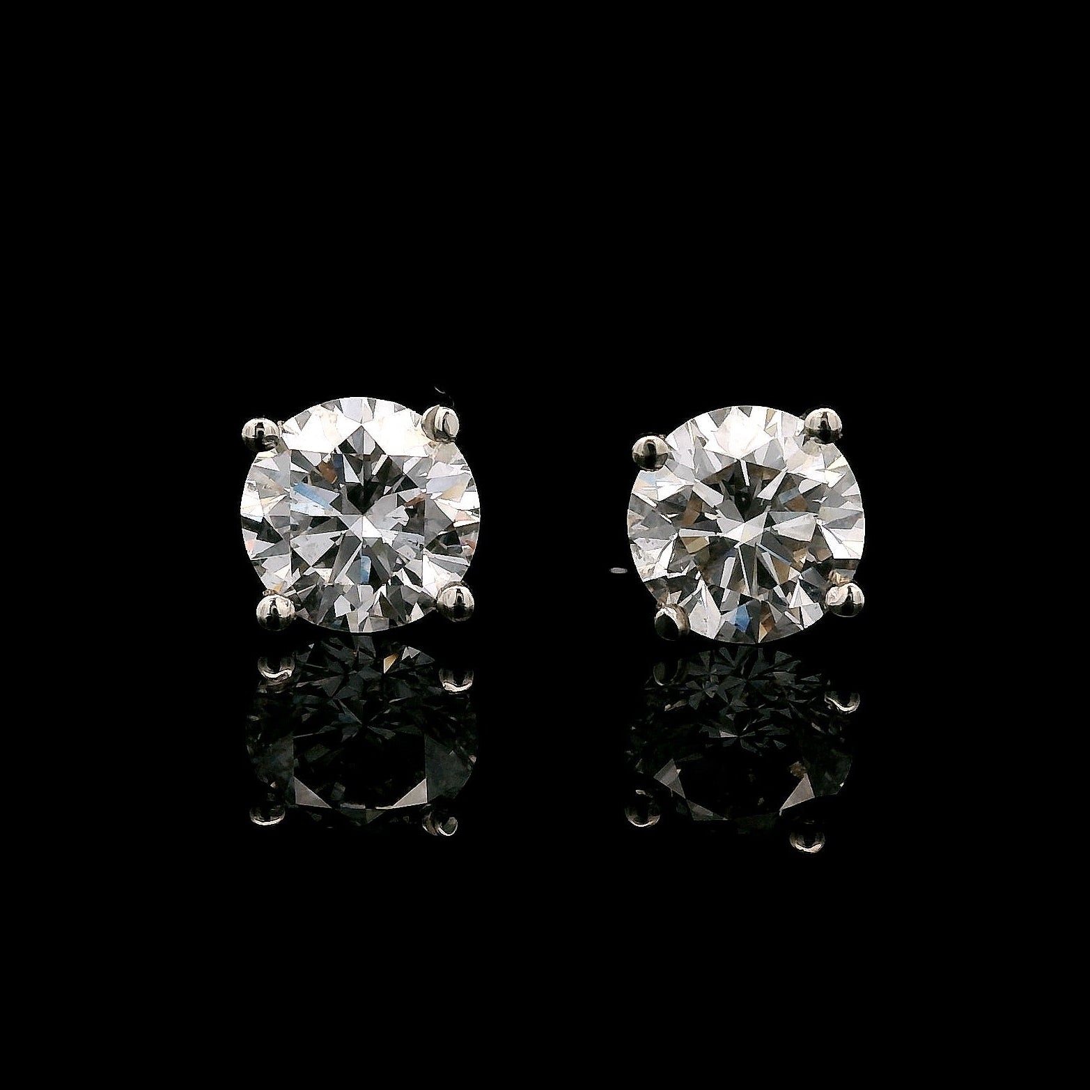 14K White gold stud earrings set with round brilliant diamonds. Item J38154 - ABC Jewelry Co
