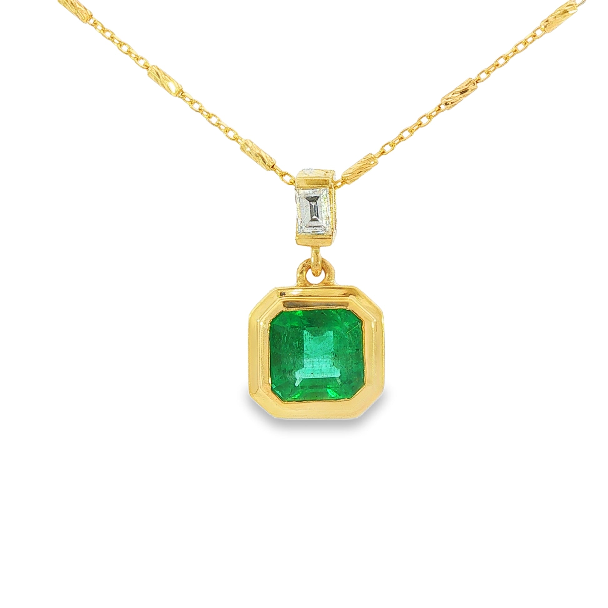 14K Yellow gold pendant necklace set with an asscher cut emerald and a baguette diamond. Item J38223 - ABC Jewelry Co. 
