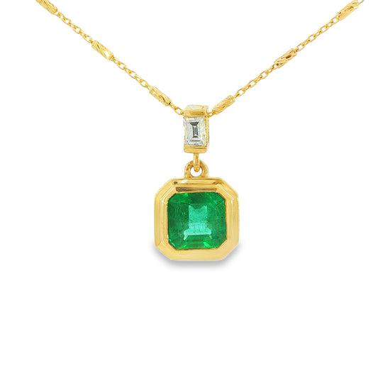 14K Yellow gold pendant necklace set with an asscher cut emerald and a baguette diamond. Item J38223 - ABC Jewelry Co. 