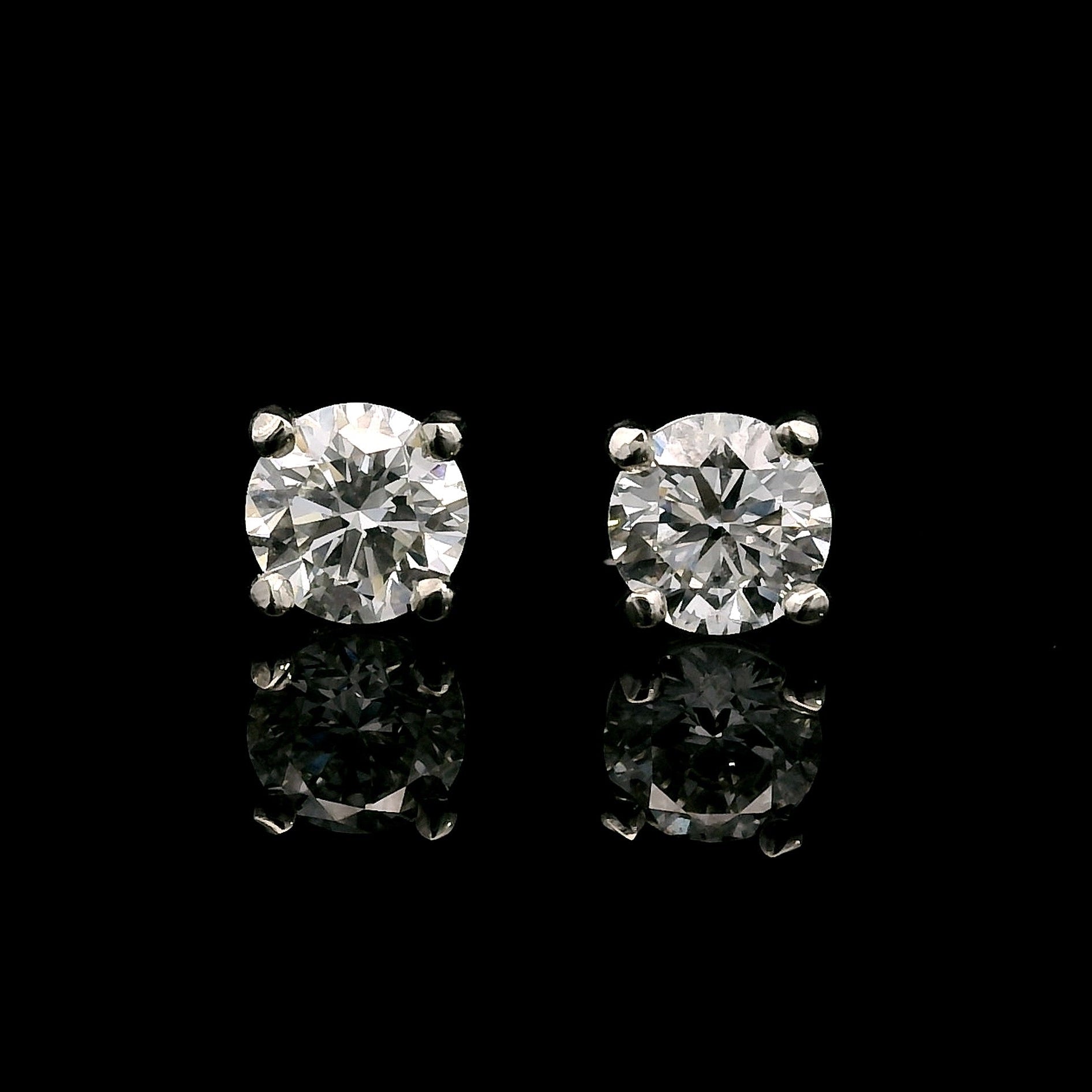 14K White gold stud earrings set with round brilliant diamonds. Item J38639 - ABC Jewelry Co. 