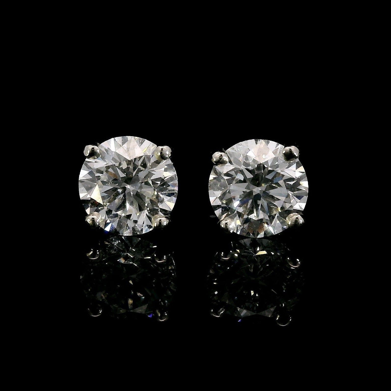 14K White gold studs set with round brilliant diamonds. Item J38704 - ABC Jewelry Co. 