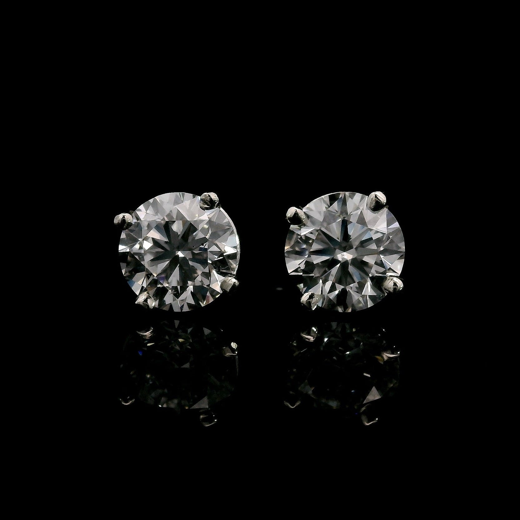 14K White gold studs set with round brilliant diamonds. Item J38705 - ABC Jewelry Co. 