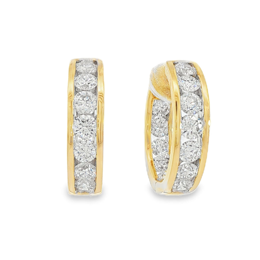 14K Yellow gold hoop earrings channel set with round brilliant diamonds. Item J38756 - ABC Jewelry Co.