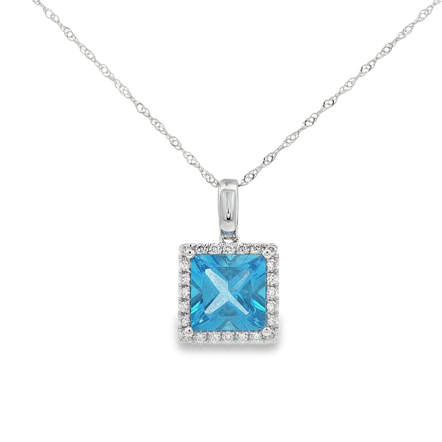 14K White gold pendant set with blue topaz and a diamond halo. Item J38757 - ABC Jewelry Co.