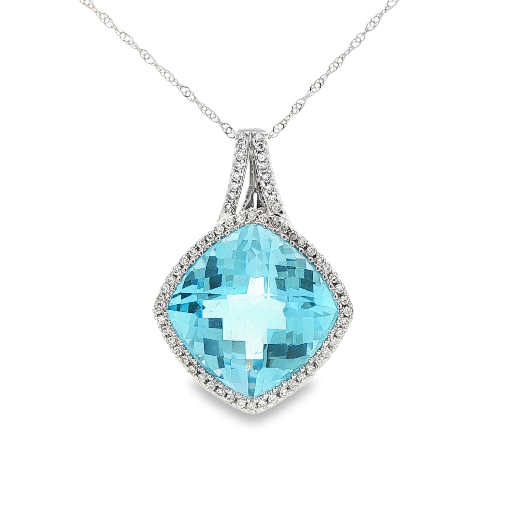 14K White gold pendant set with a blue topaz and a diamond halo. Item J38767 - ABC Jewelry Co.