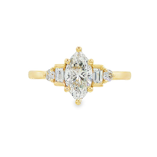 14K Yellow gold ring set with a marquise diamond flanked by baguette and round brilliant diamonds. Item J38803 - ABC Jewelry Co.