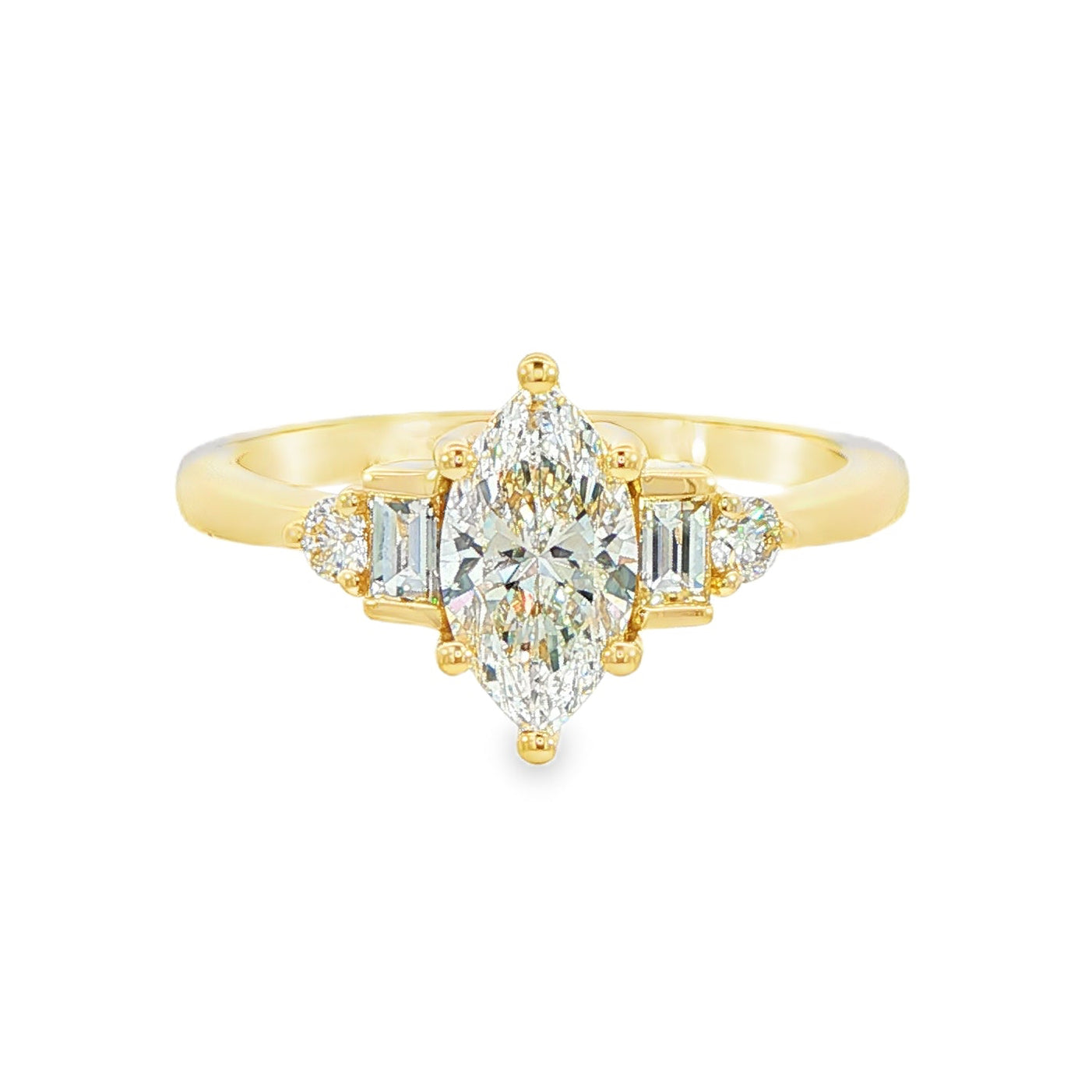 14K Yellow gold ring set with a marquise diamond flanked by baguette and round brilliant diamonds. Item J38803 - ABC Jewelry Co.