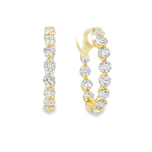 18K Yellow gold hoop earrings set with round brilliant diamonds. Item J38919 - ABC Jewelry Co.