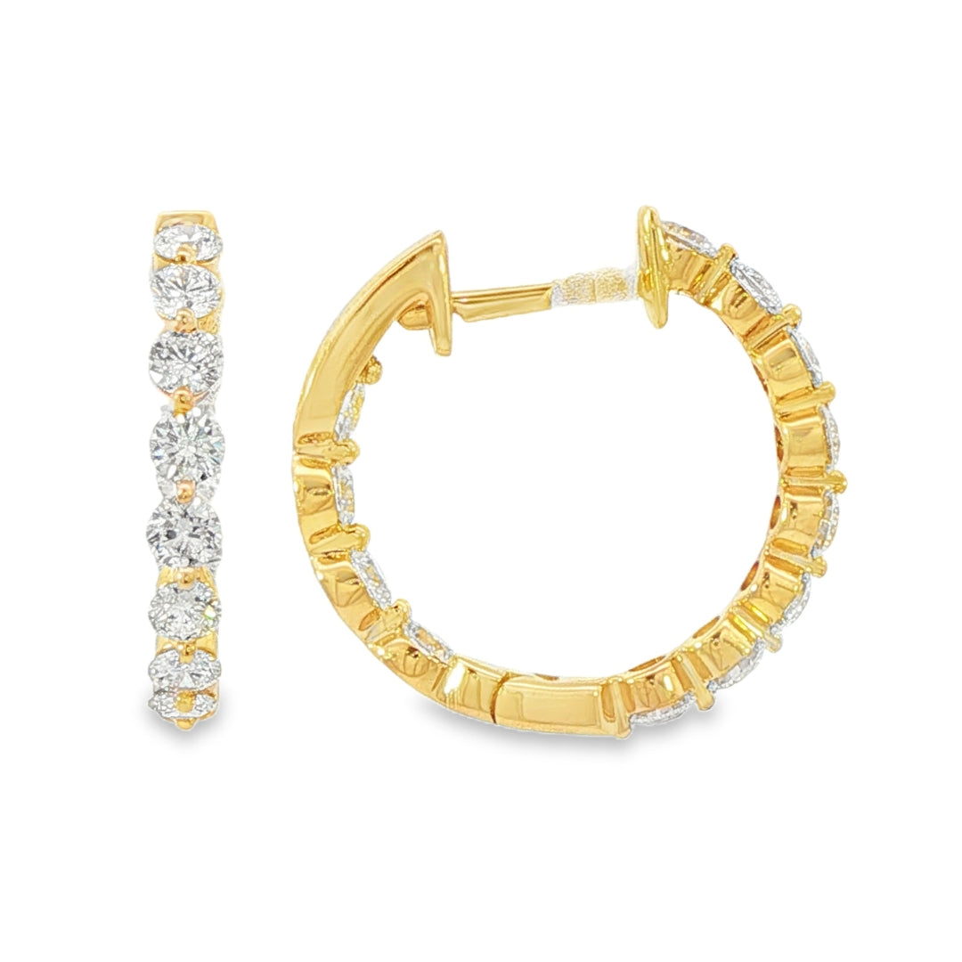 18K Yellow gold hoop earrings set with round brilliant diamonds. Item J38919 - ABC Jewelry Co.