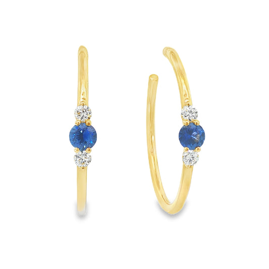 14K Yellow gold hoop earrings, each set with a round blue sapphire flanked by two round diamonds. Item - J39003 - ABC Jewelry Co. 