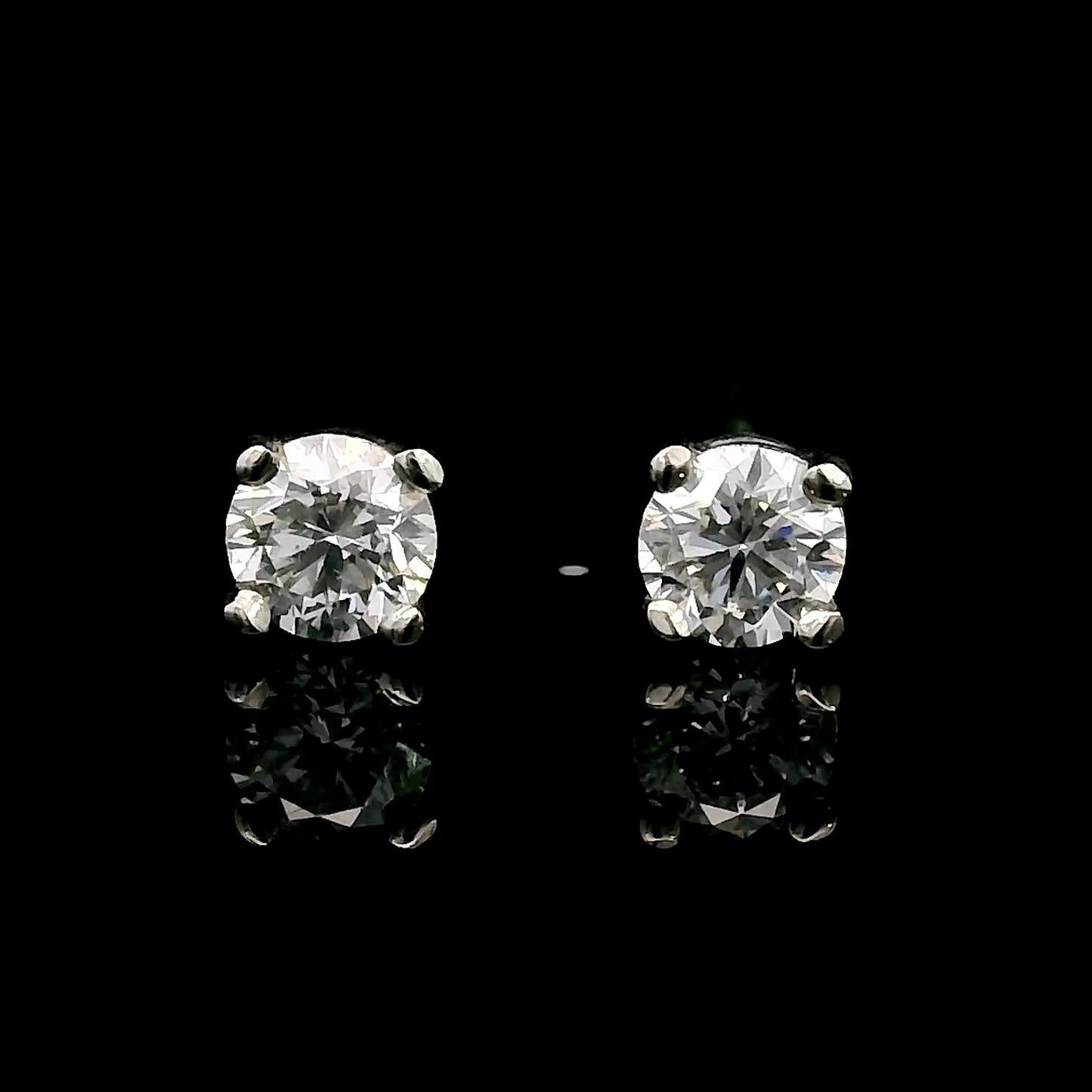 14K White gold stud earrings set with round brilliant diamonds. Item J39014 - ABC Jewelry Co. 