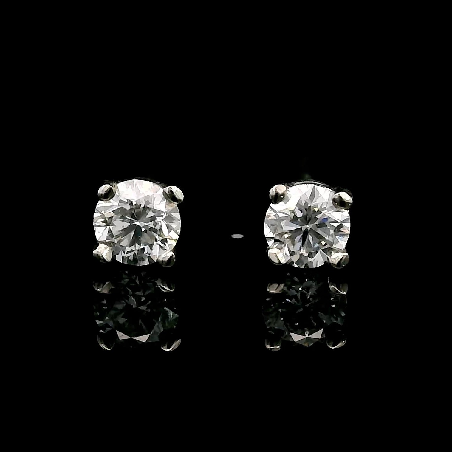 14K White gold stud earrings set with round brilliant diamonds. Item J39014 - ABC Jewelry Co. 