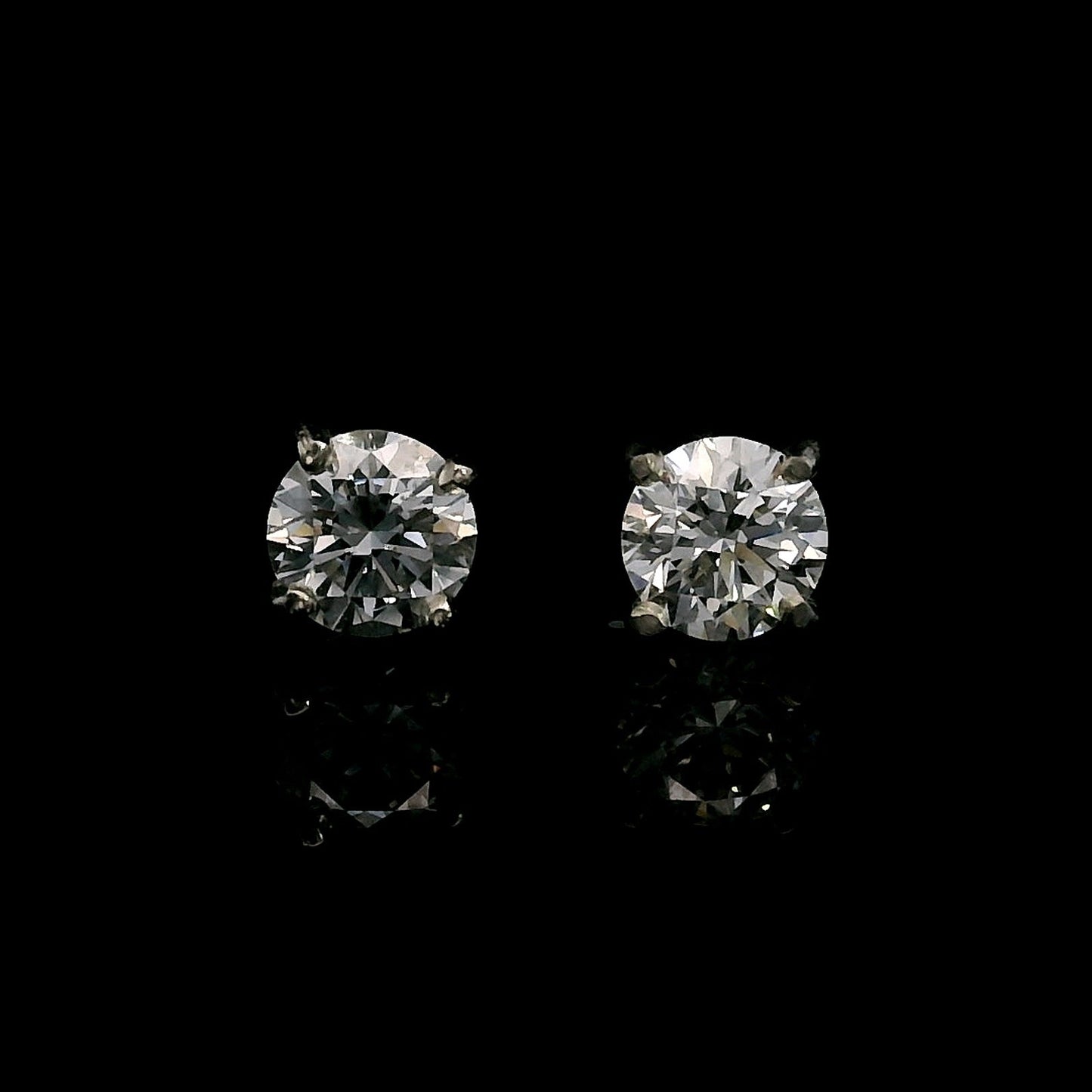 14K White gold stud earrings set with round brilliant diamonds. Item J39015 - ABC Jewelry Co. 