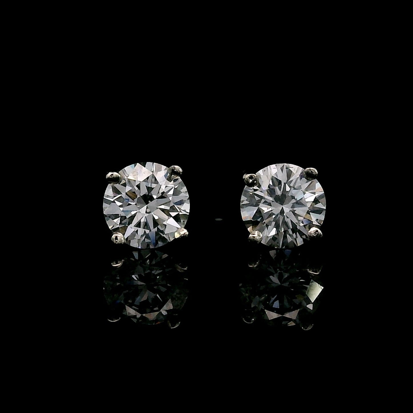 14K White gold stud earrings set with round brilliant diamonds. Item J39016 - ABC Jewelry Co. 