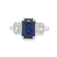 14K White gold ring set with an emerald cut sapphire and two diamonds. Item J39215 - ABC Jewelry Co. 