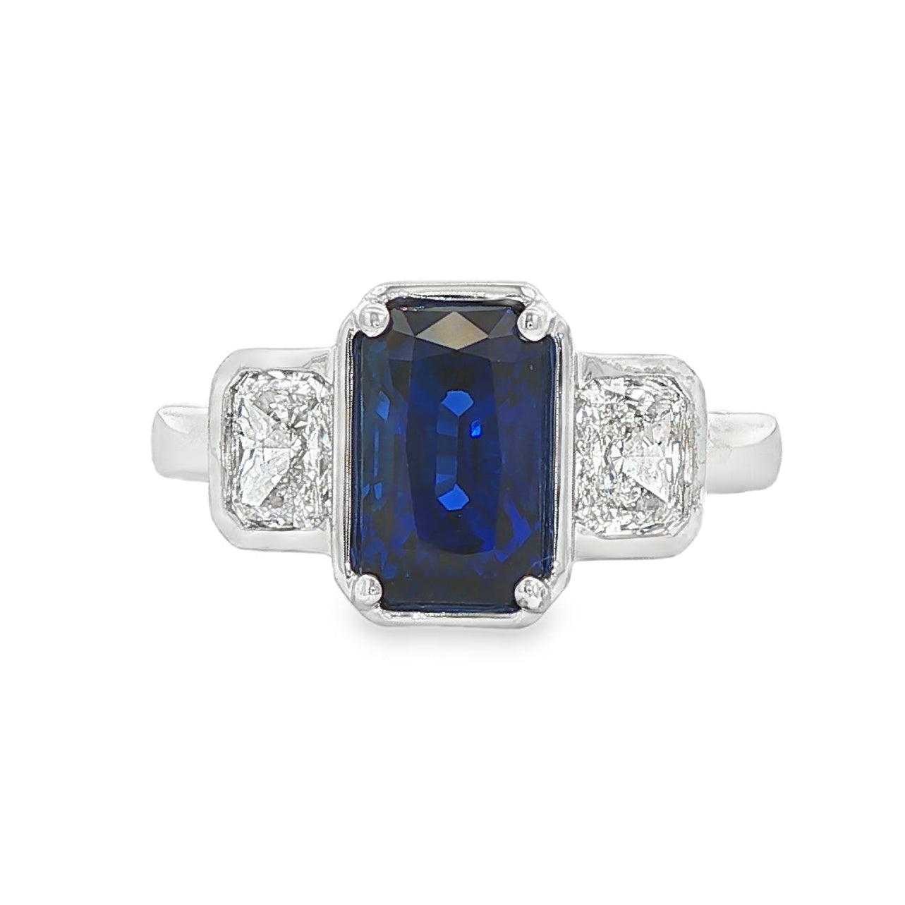 14K White gold ring set with an emerald cut sapphire and two diamonds. Item J39215 - ABC Jewelry Co. 