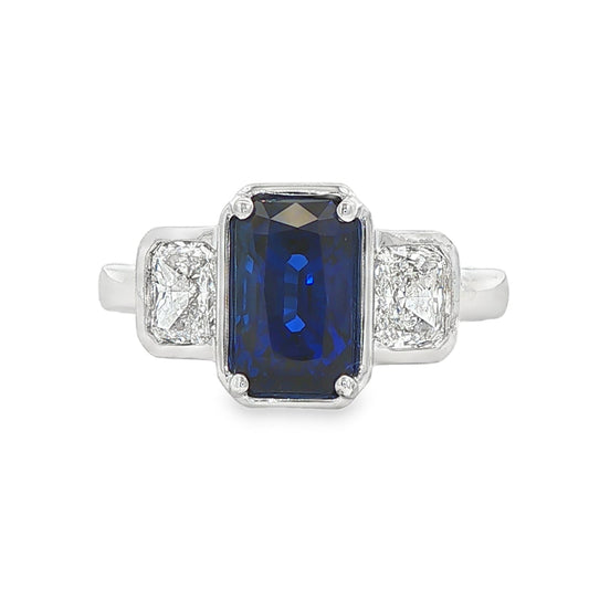 14K White gold ring set with an emerald cut sapphire and two diamonds. Item J39215 - ABC Jewelry Co. 