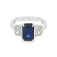 14K White gold ring set with an emerald cut sapphire and two diamonds. Item J39215 - ABC Jewelry Co. 