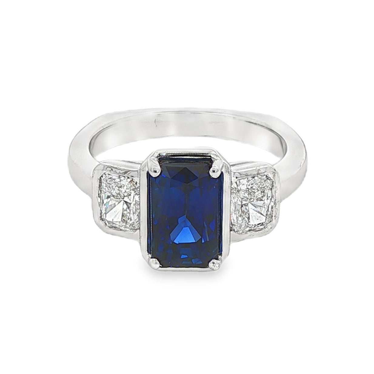 14K White gold ring set with an emerald cut sapphire and two diamonds. Item J39215 - ABC Jewelry Co. 