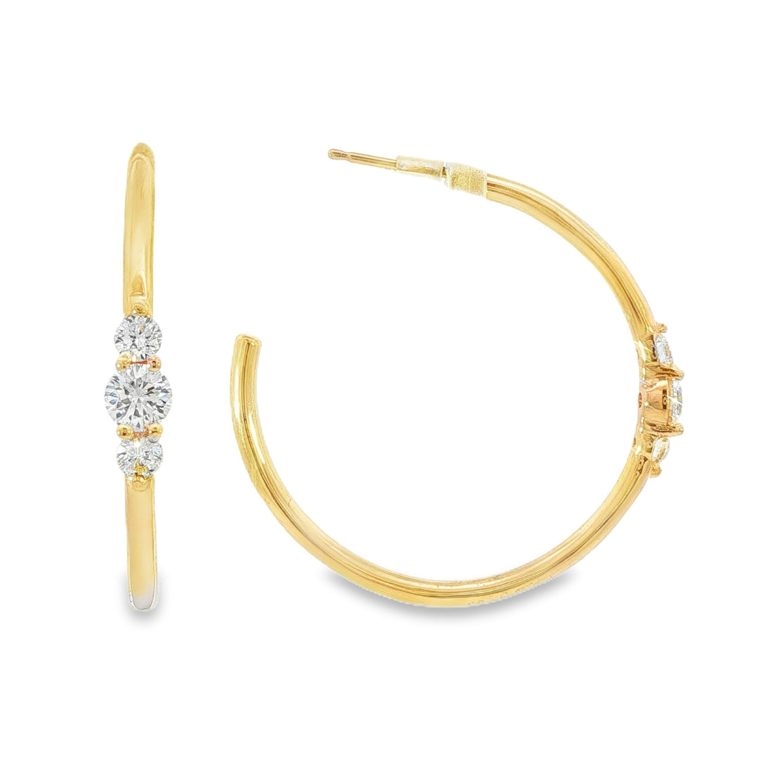 14K Yellow gold hoop earrings each set with a row of three round brilliant diamonds. Item J39217 - ABC Jewelry Co. 