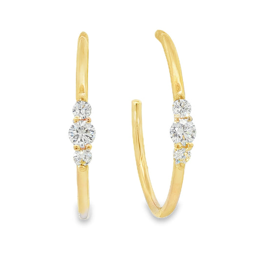 14K Yellow gold hoop earrings each set with a row of three round brilliant diamonds. Item J39217 - ABC Jewelry Co. 