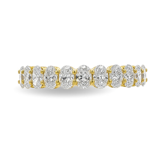 A yellow gold  band ring set with a row of oval cut diamonds, shown on a clean white background.