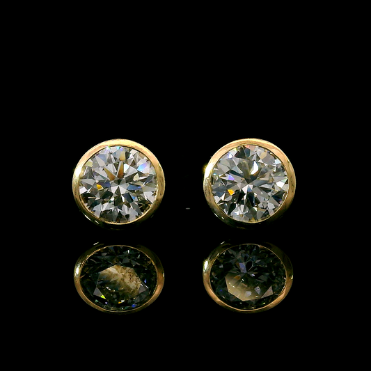 Yellow gold bezel set stud earrings set with round brilliant diamonds