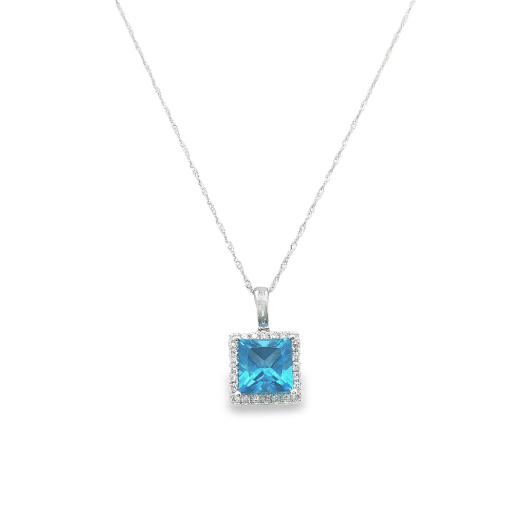 14K White gold pendant set with blue topaz and a diamond halo. Item J38757 - ABC Jewelry Co.