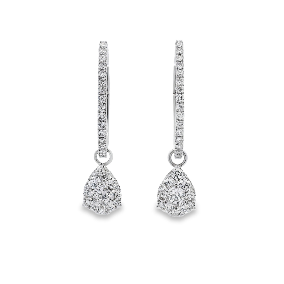 18K White gold earring jackets featuring clusters of diamonds, shown on white gold diamond hoop earrings. Item J35758 - ABC Jewelry Co