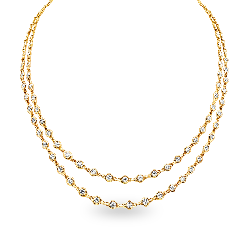 A double-strand gold necklace featuring small round diamonds set along the chain, displayed set on a white background.