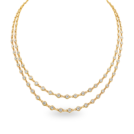 A double-strand gold necklace featuring small round diamonds set along the chain, displayed set on a white background.