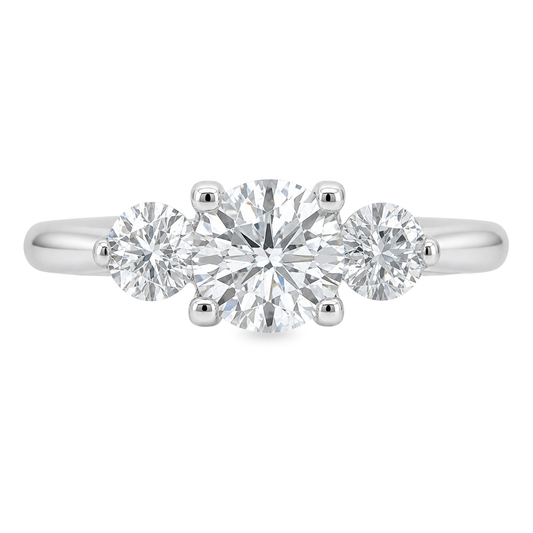 White gold three stone ring with round brilliant diamonds. Set on plain white background. 