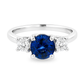White gold ring with a round blue sapphire flanked by diamonds set on white background