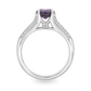 Profile view of white gold ring set with purple sapphire. Shown on a clean white background.