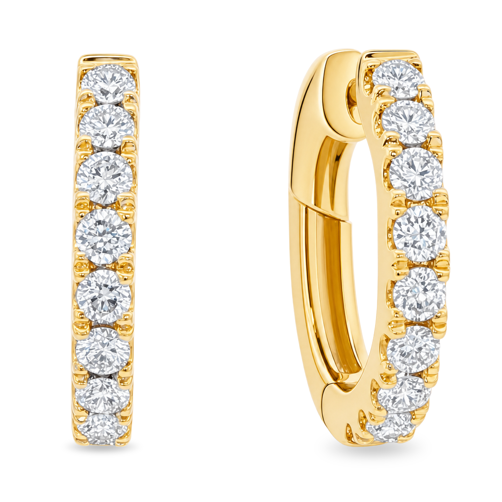 A pair of gold huggie hoop earrings set with round-cut clear gemstones, shown from the front and side on a plain white background.