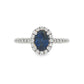 18K White gold ring set with an oval blue sapphire surrounded by a diamond halo. Item J30904 - ABC Jewelry Co. 
