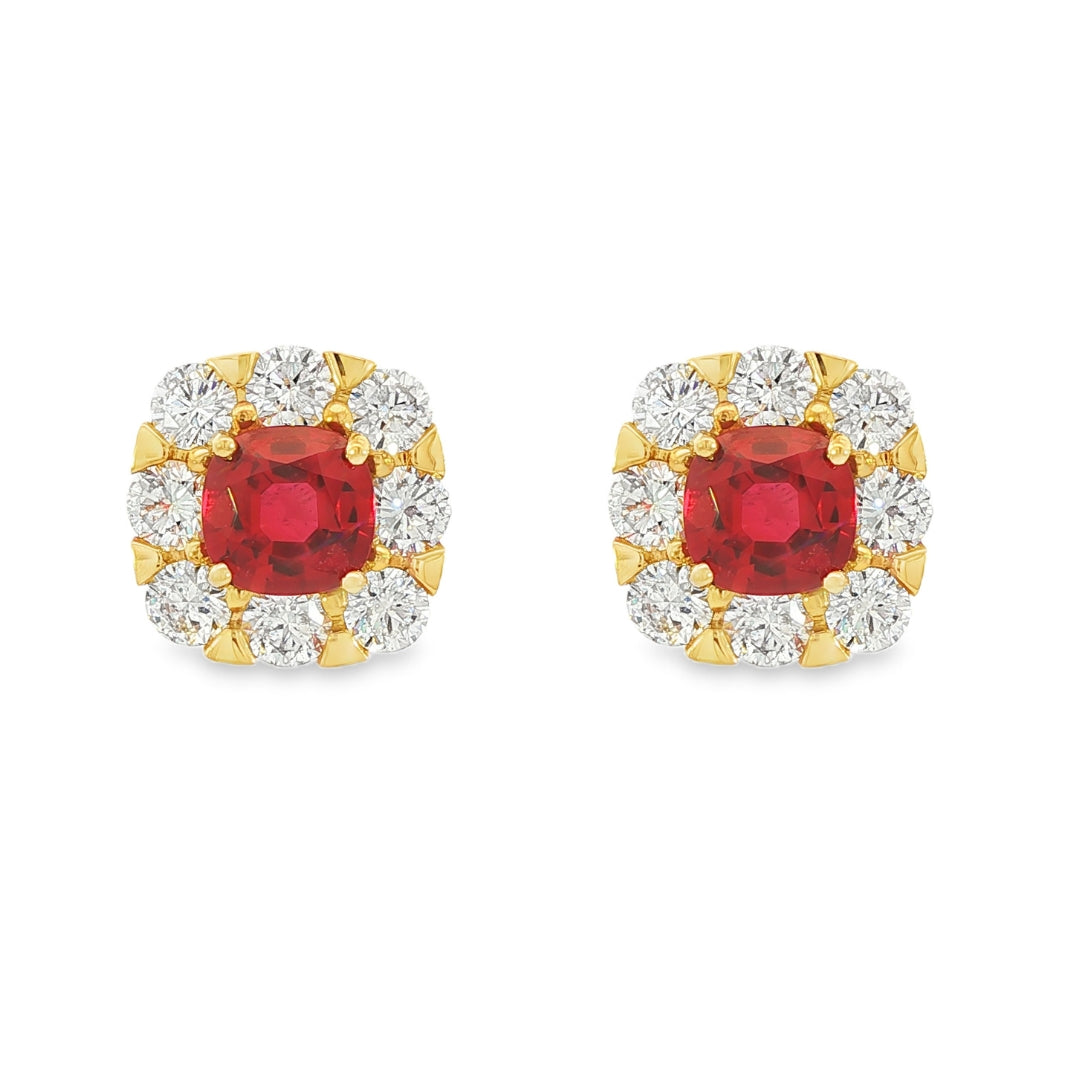 18K Yellow gold earrings set with round red rubies surrounded by a halo of round brilliant diamonds. Item J35757 - ABC Jewelry Co.