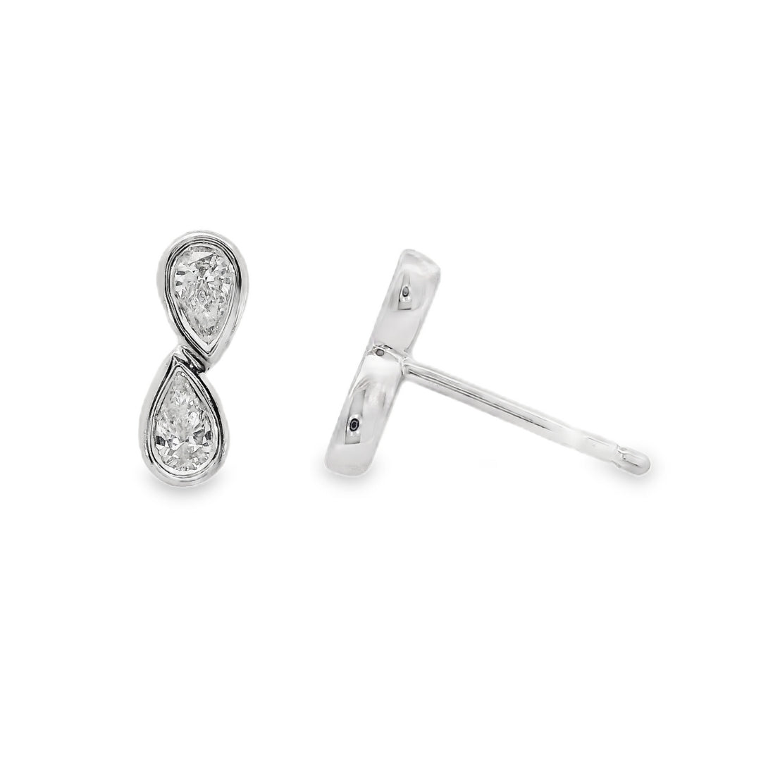 18K White gold diamond earrings, each set with two pear shape diamonds in a vertical design. Item J37096 - ABC Jewelry Co