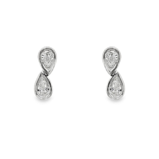 18K White gold diamond earrings, each set with two pear shape diamonds in a vertical design. Item J37096 - ABC Jewelry Co