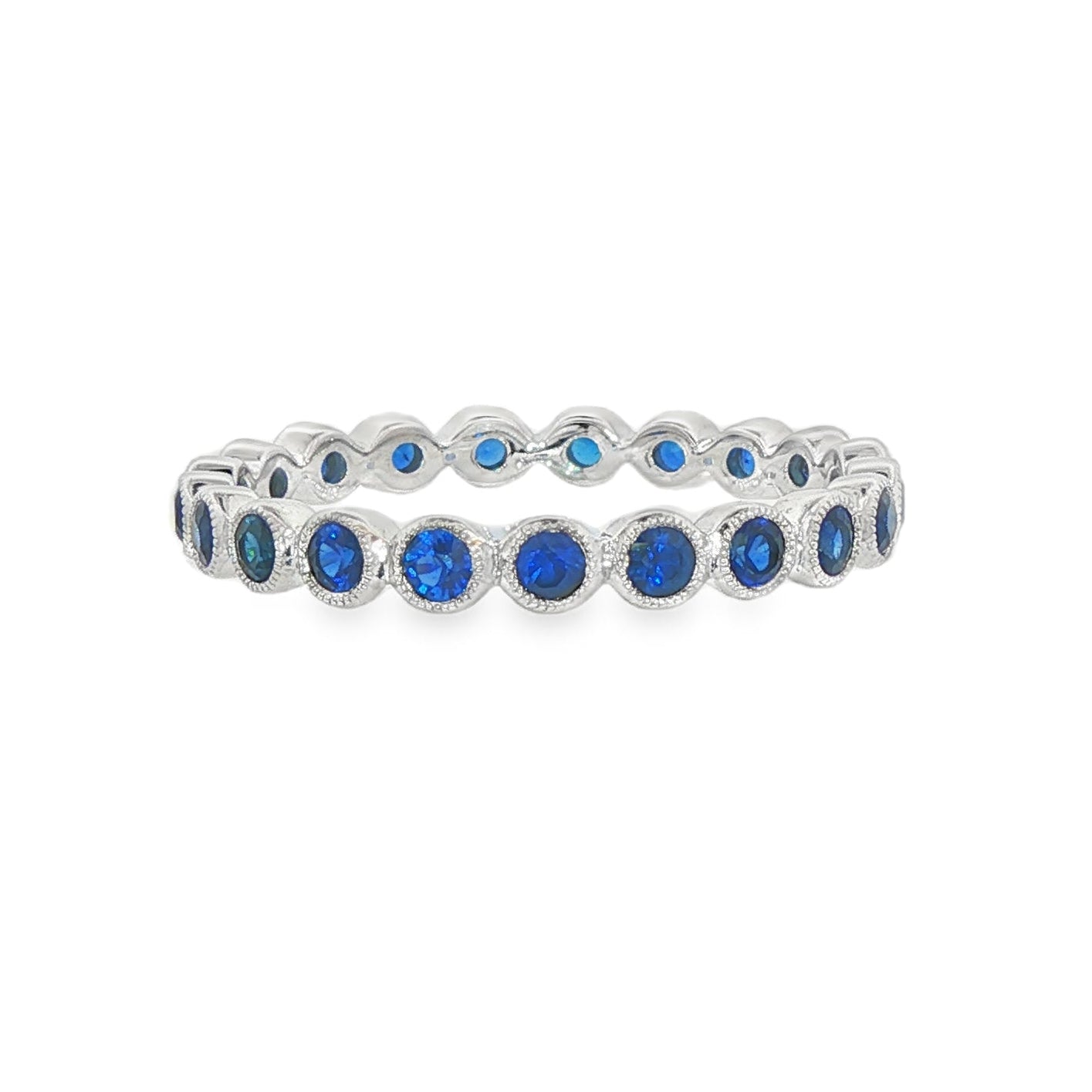 14K White gold eternity band bezel set with round blue sapphires. Item J37389 - ABC Jewelry Co. 