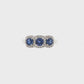18K White gold ring set with three deep blue sapphires, each surrounded by diamond halo. Item J35620 - ABC Jewelry Co.